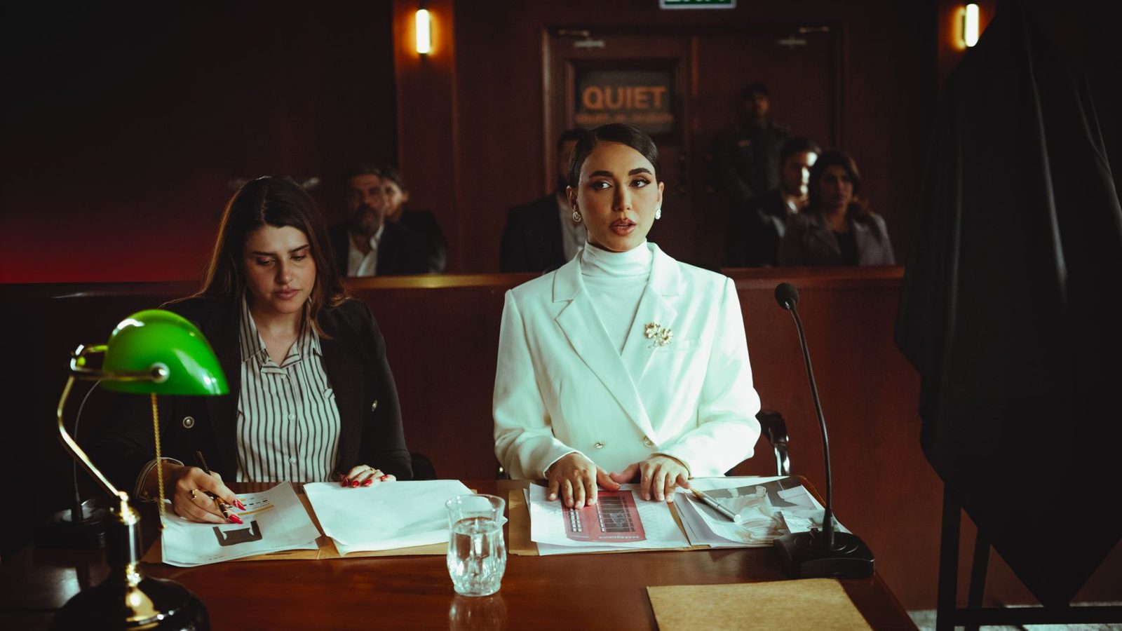 Female lawyers reviewing legal documents in a courtroom.